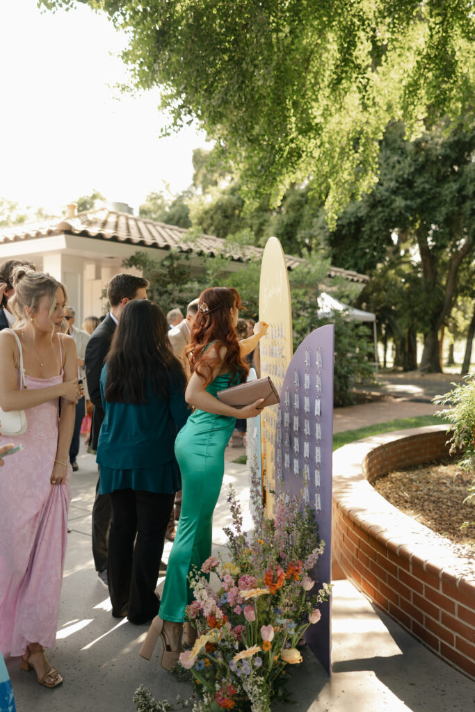 wedding guests collect their seating assignment