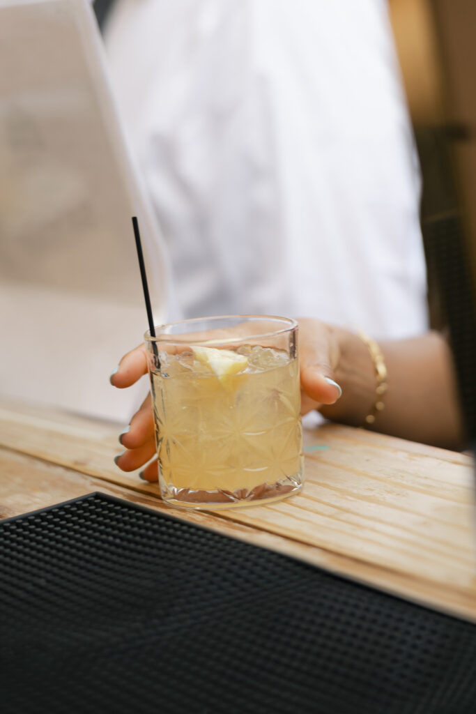 wedding guest picking up cocktail during cocktail hour