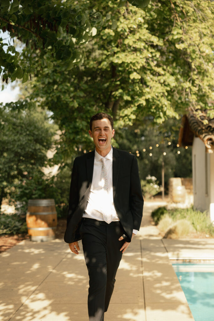 groomsmen smiles as he is introduced
