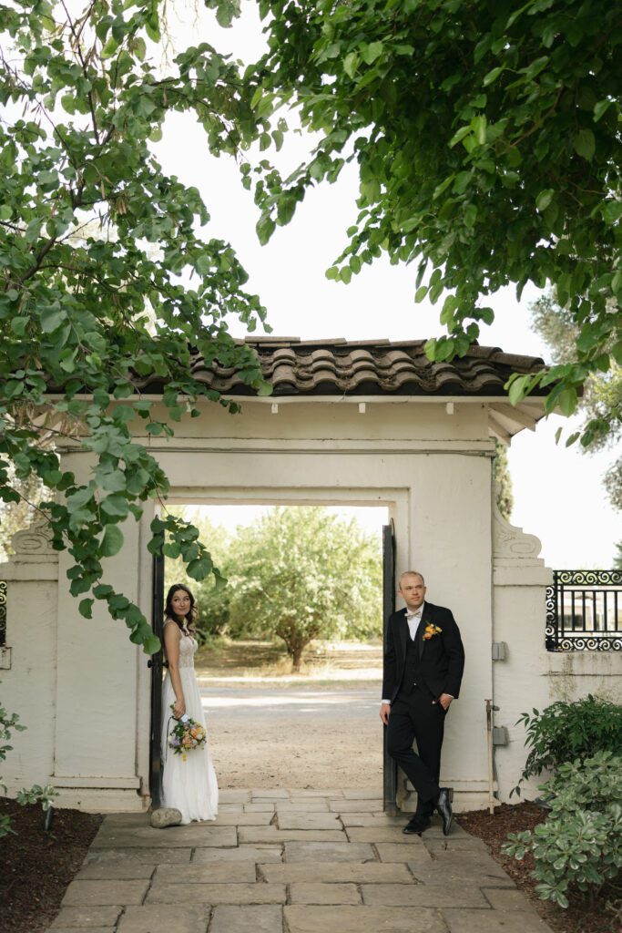 editorial photo of bride and groom under arch