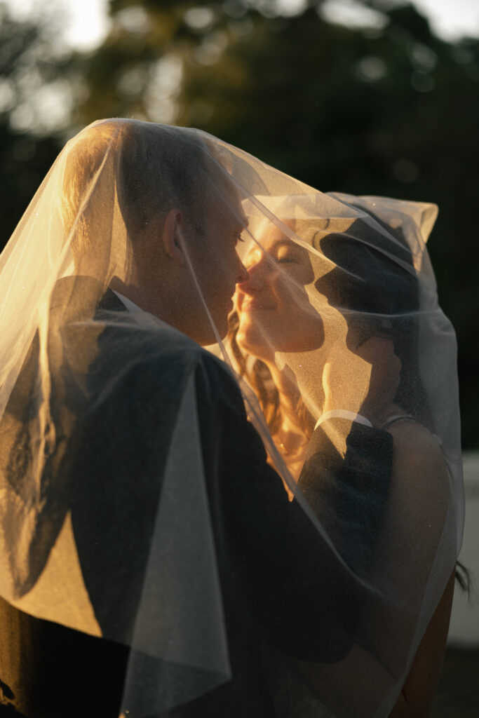 golden hour photos with bride and groom kissing