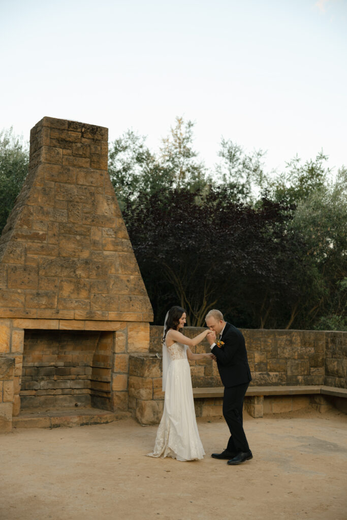 groom kisses bride's hand