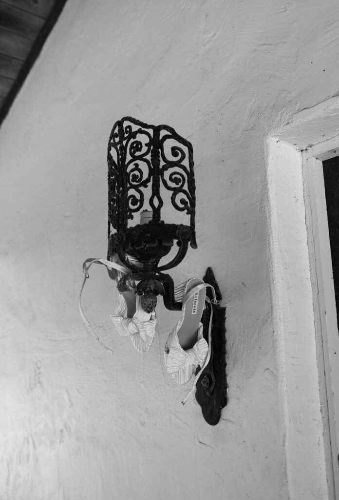 wedding shoes hanging from light