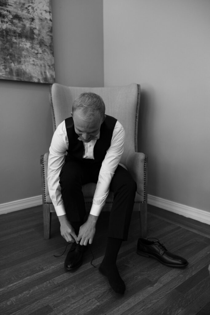 groom putting shoes on
