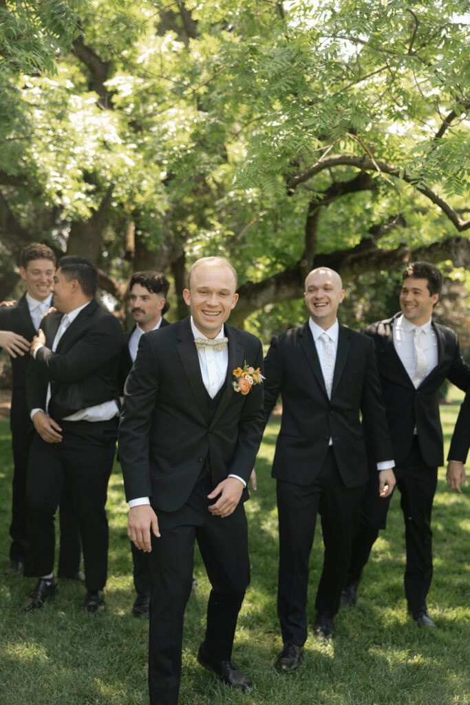 groom and groomsmen laughing together