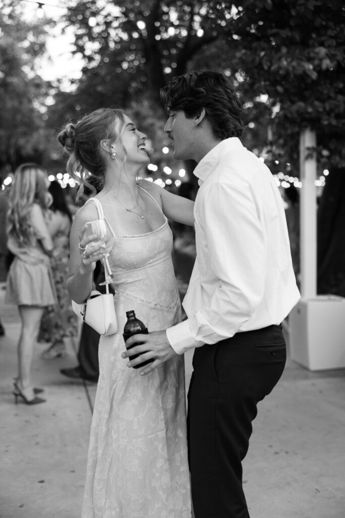 a wedding guest couple share a sweet moment dancing