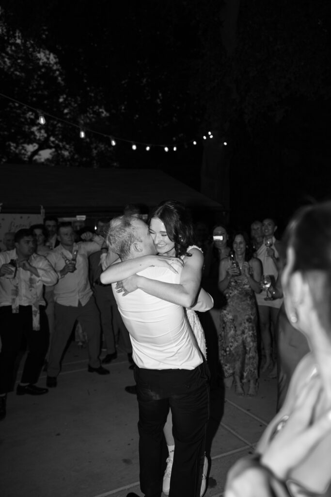 groom picks up bride during sacramento wedding reception