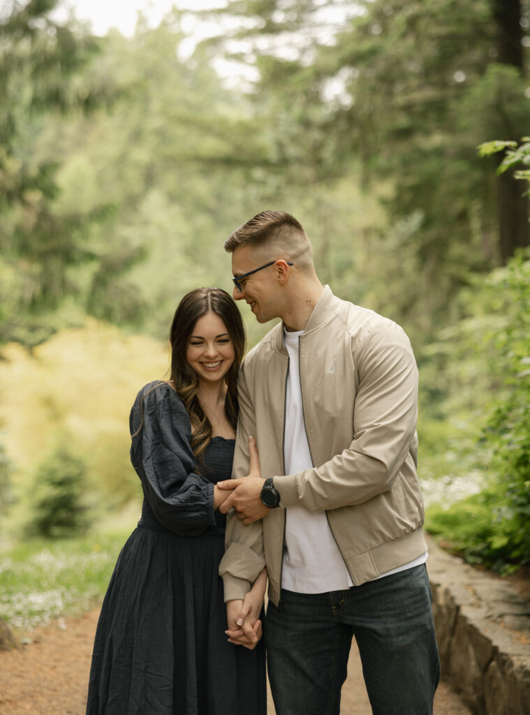 couple are holding hand and leaning into each other as they are laughing