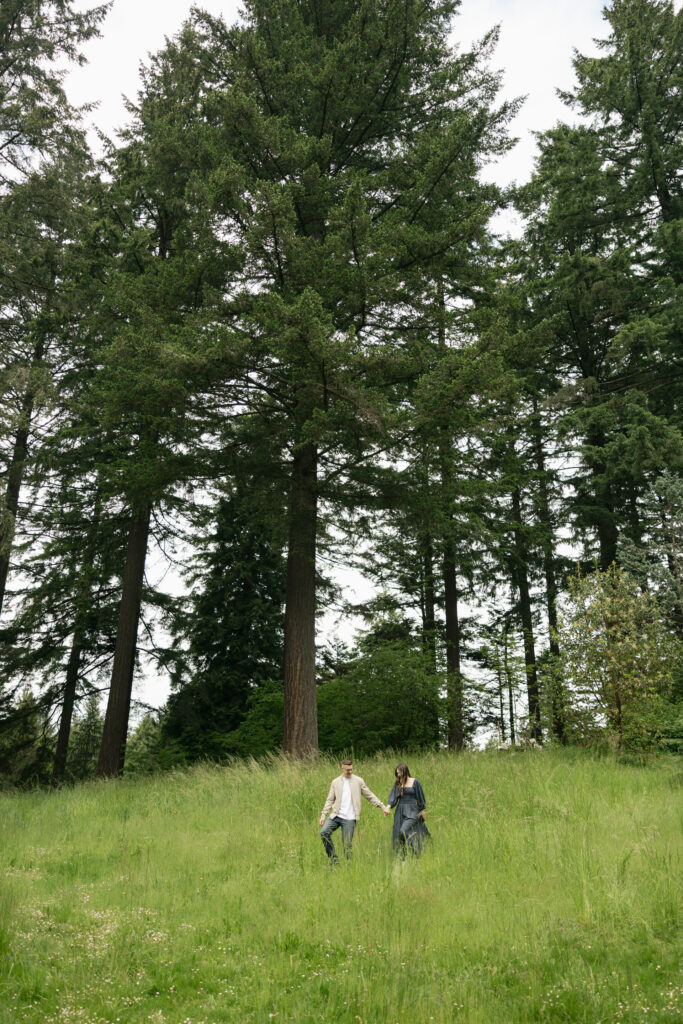 man leads woman down hill at hoyt arboretum portland