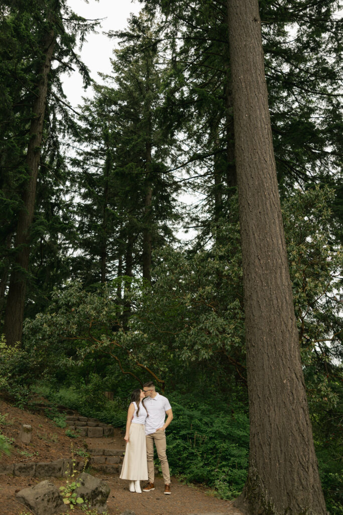 couple kissing on trail at hoyt arboretum portland