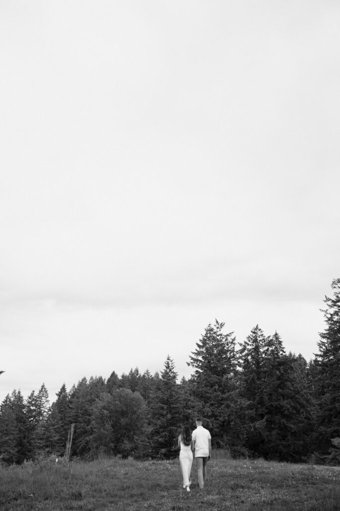 couple walks in open field