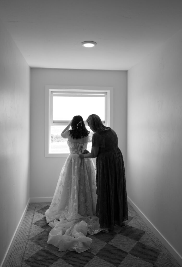 mom lacing up brides dress