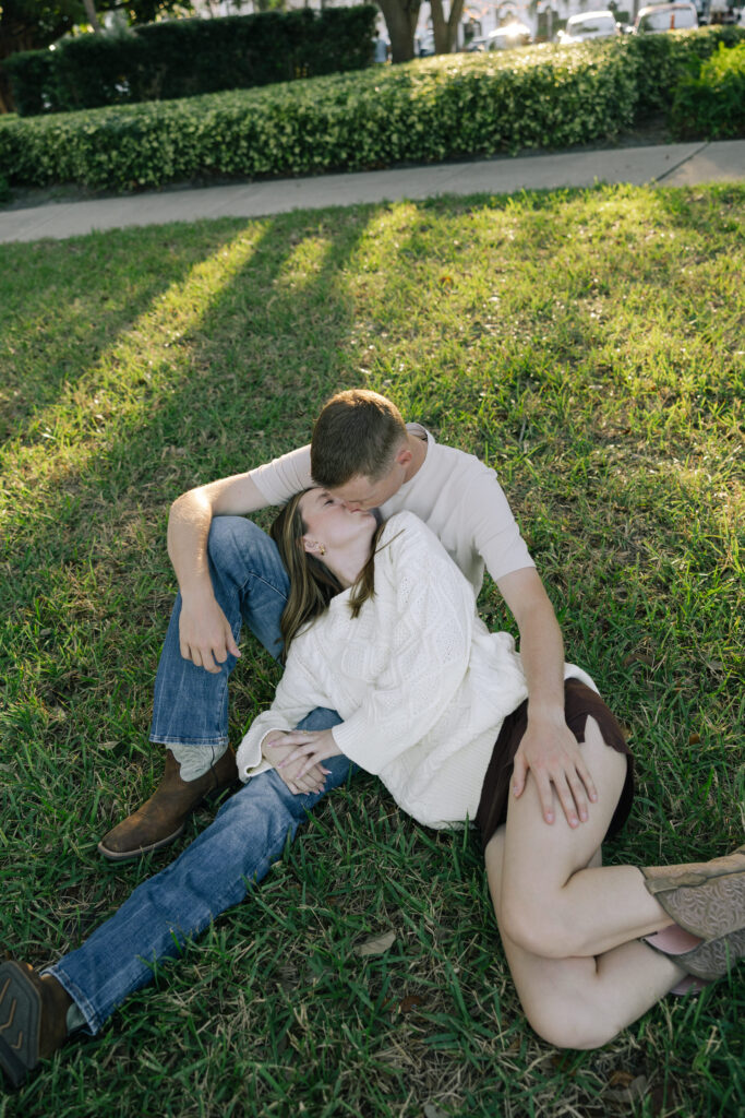 guy sitting down and girl laying on his lap