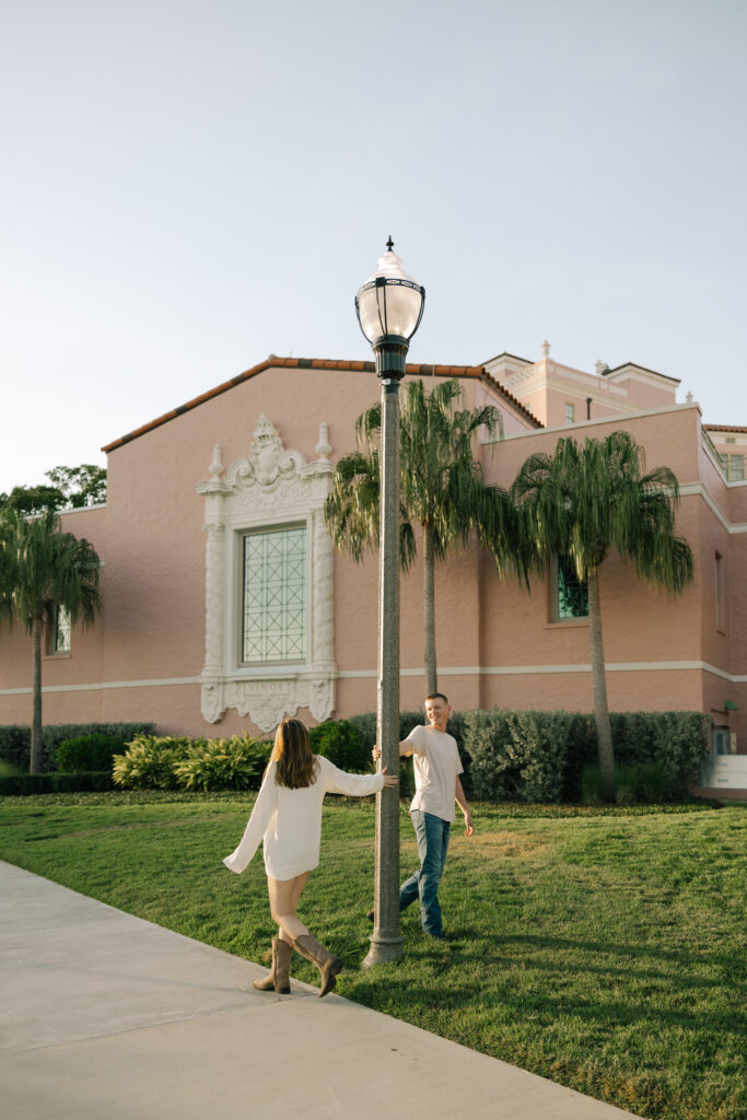 couple swinging around lightpole in front of Vinoy in St petersburg