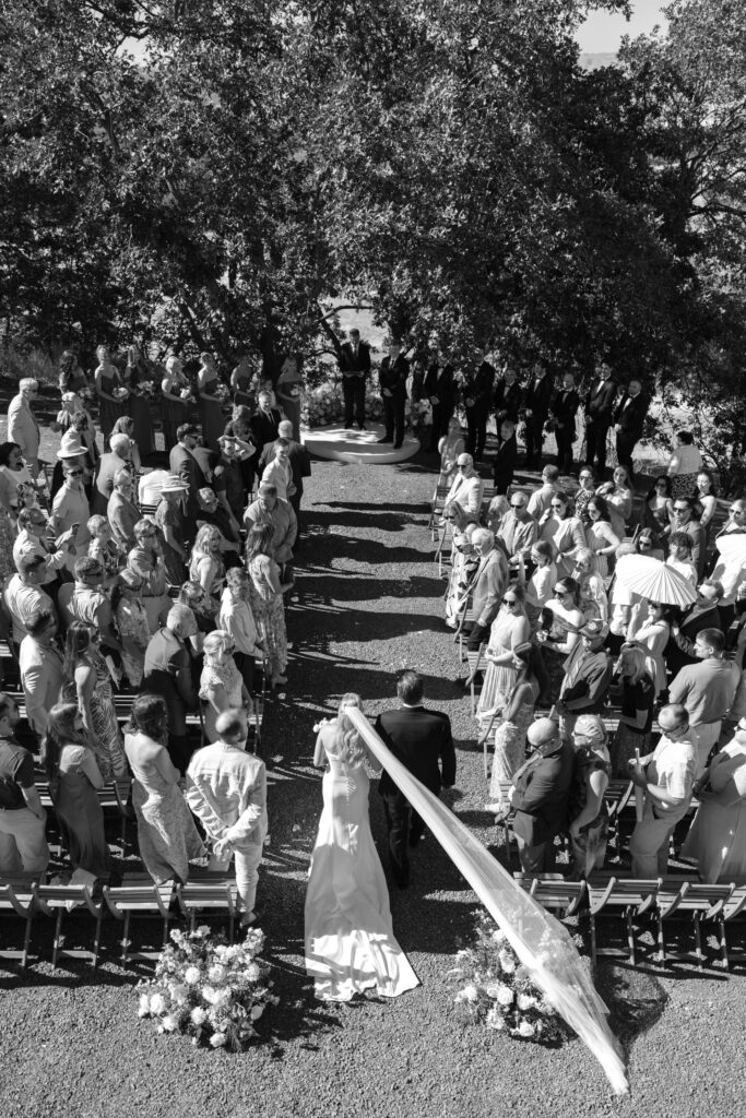 bride walking down aisle from above in black & white