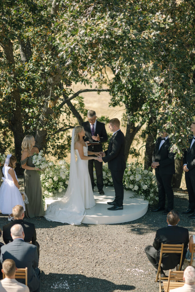 bride and groom standing on platform during ceremony
