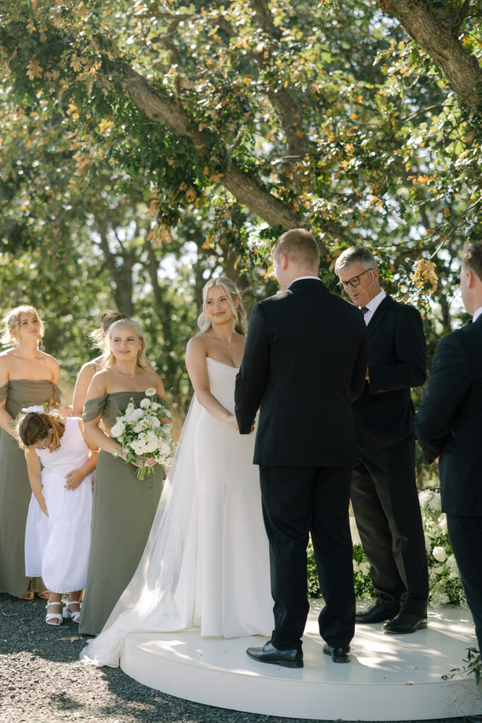 bride looking out at guests during wedding ceremony in Oregon