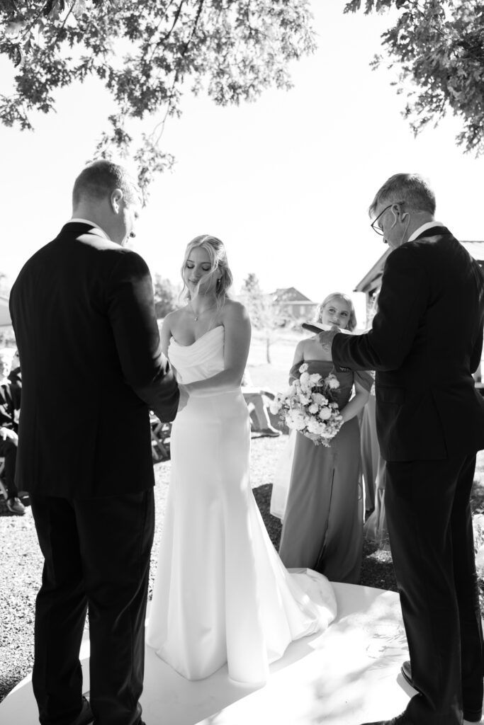 black and white image taken of couple from beside officiant