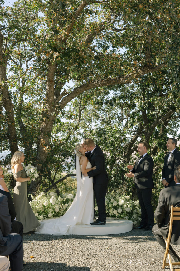wedding couples first kiss on platform during ceremony