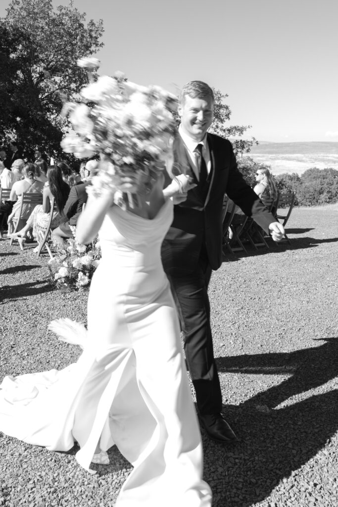 black & white motion blur of wedding couple walking down the aisle