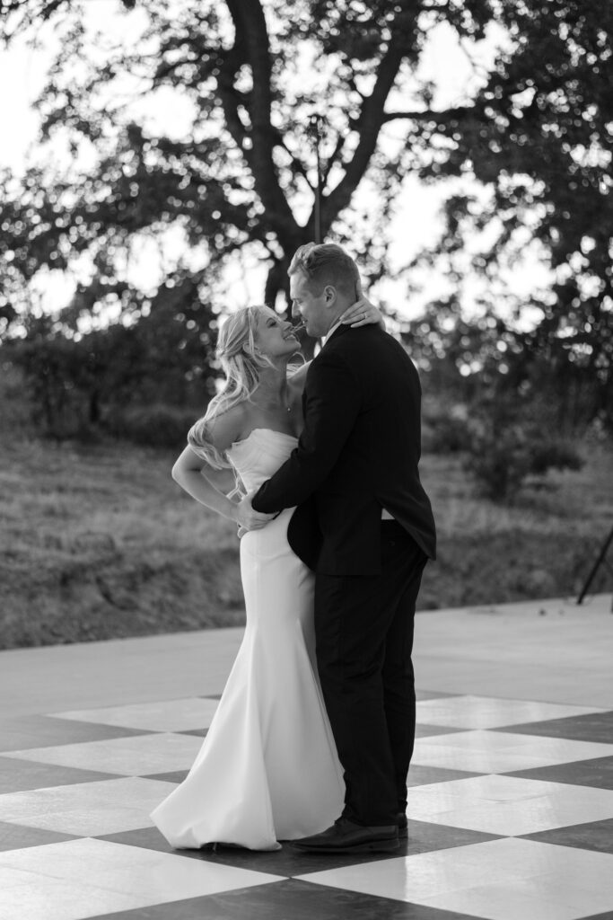 bride and groom dancing on checked floor at first dance