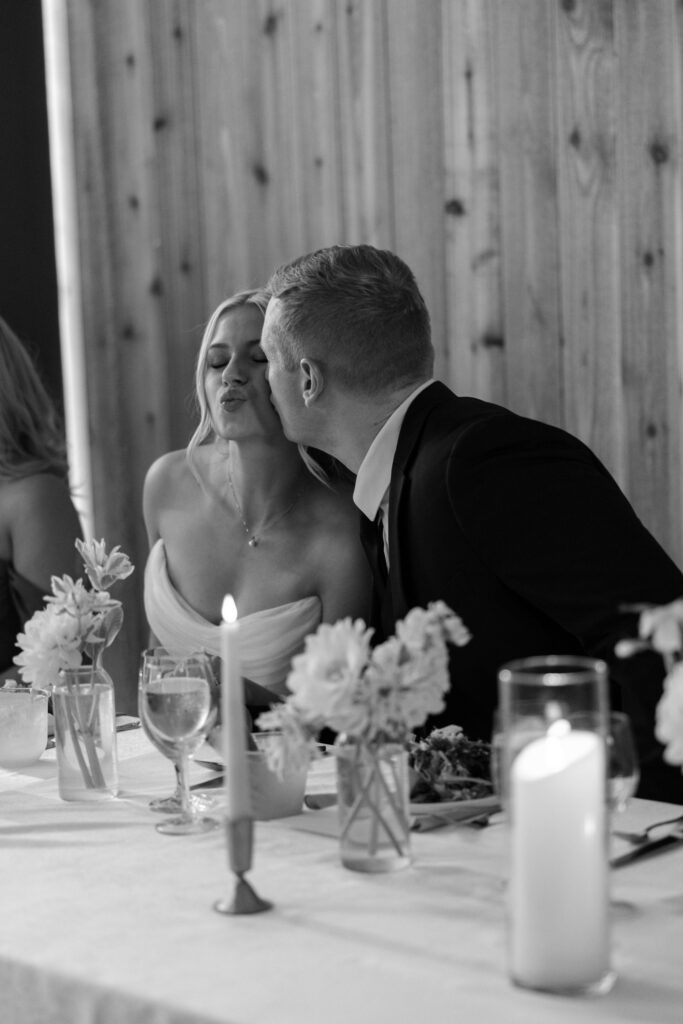 bride and groom sharing a playful kiss during reception