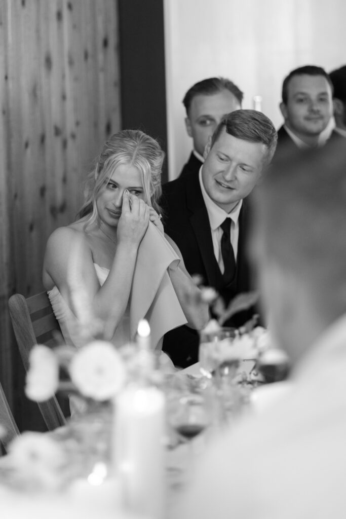 bride wiping her tear during speeches