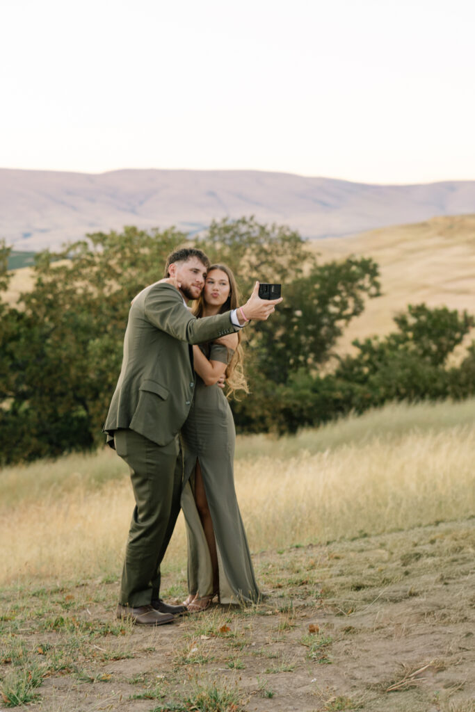 wedding guests taking pictures during sunset