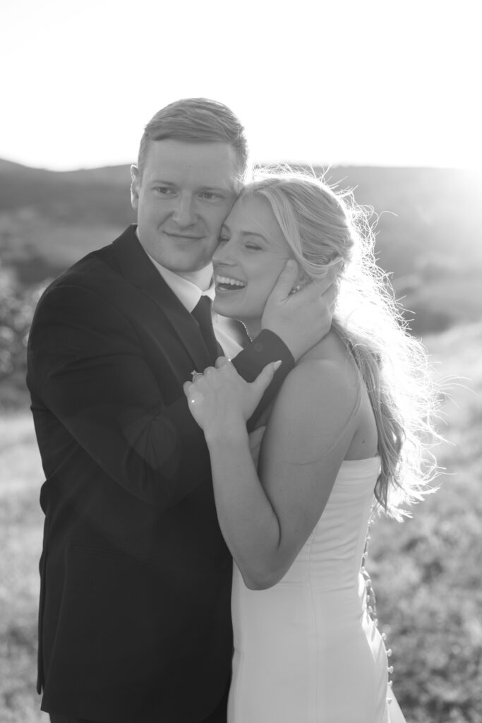 groom embracing his laughing bride