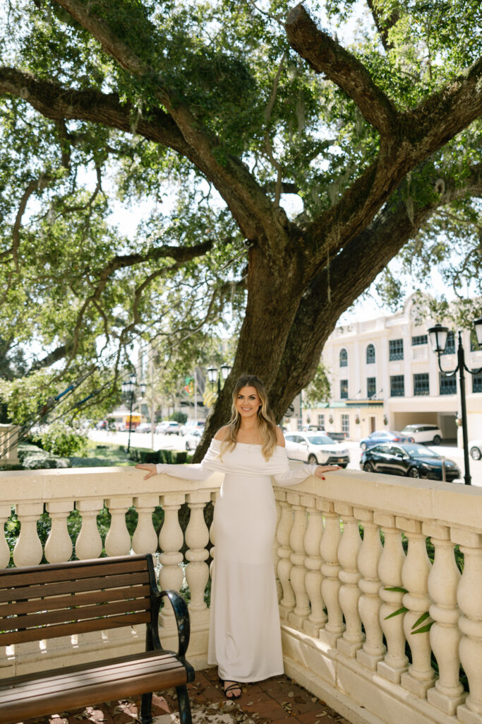 bride standing in corner of balcony smiling