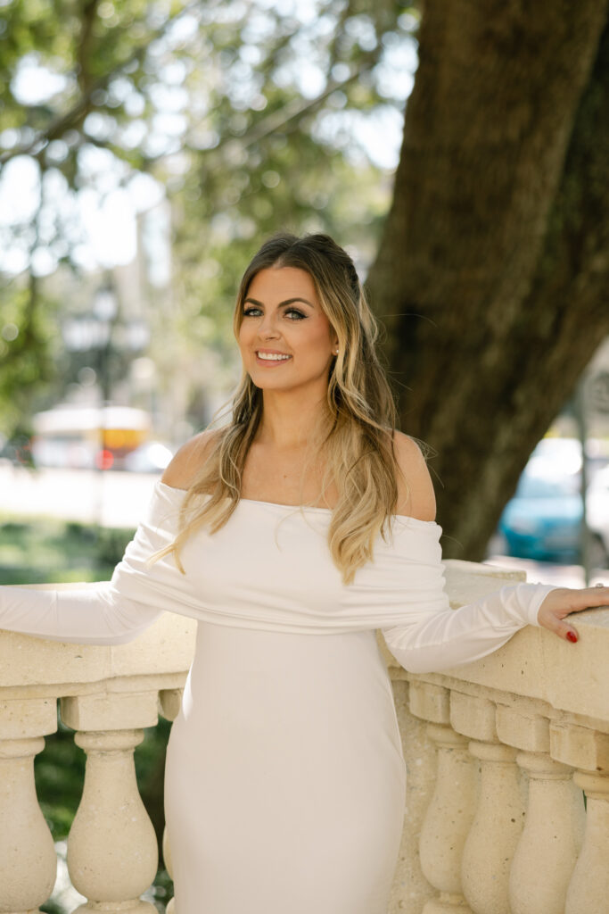 bride standing in corner of balcony smiling