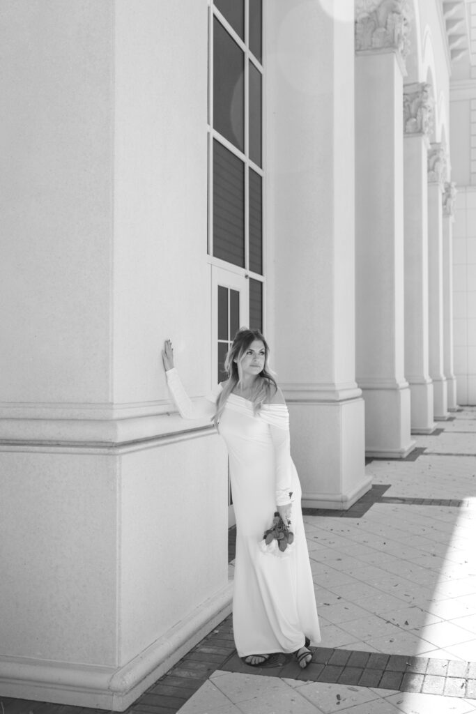 bride leaning against pillars looking out