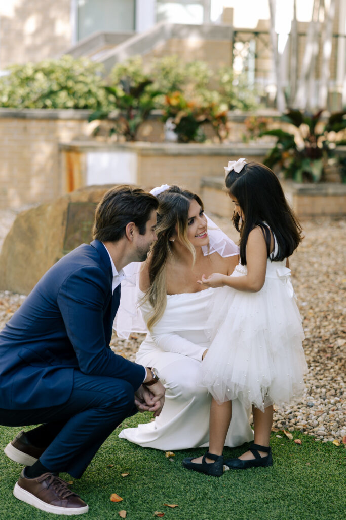 wedding couple talking to daughter after ceremony