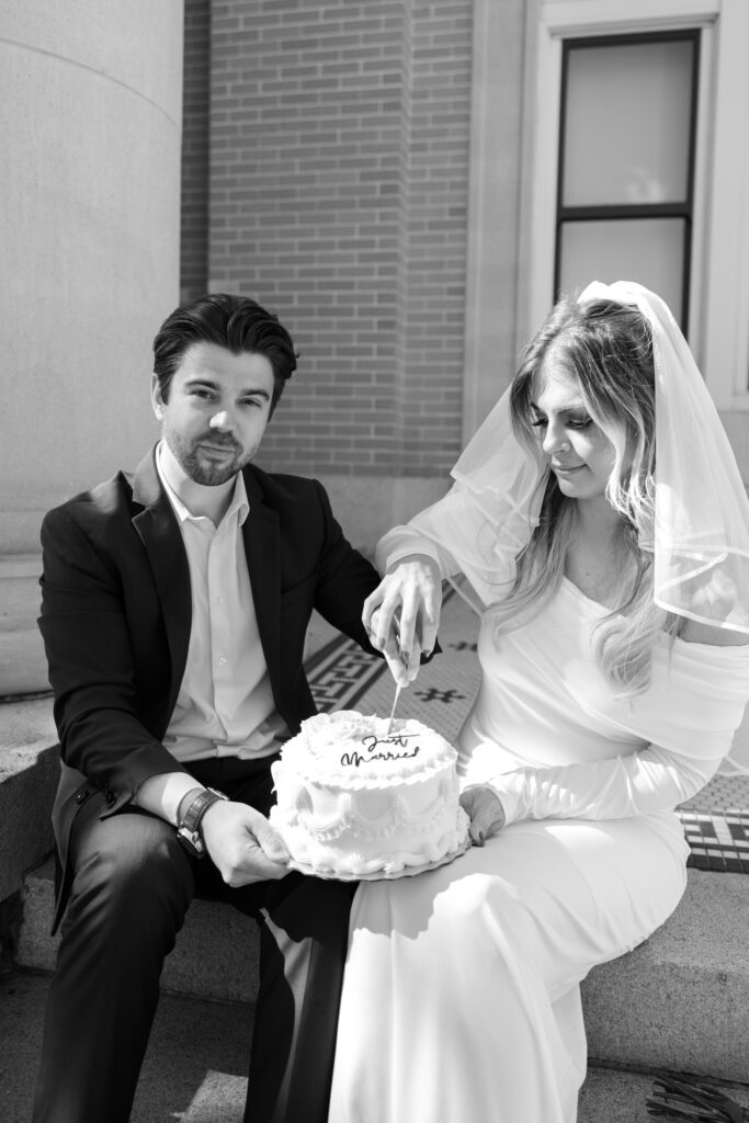 couple sitting on Old Pinellas County Courthouse steps eating cake