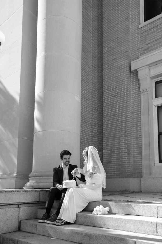 couple sitting on Old Pinellas County Courthouse steps eating cake