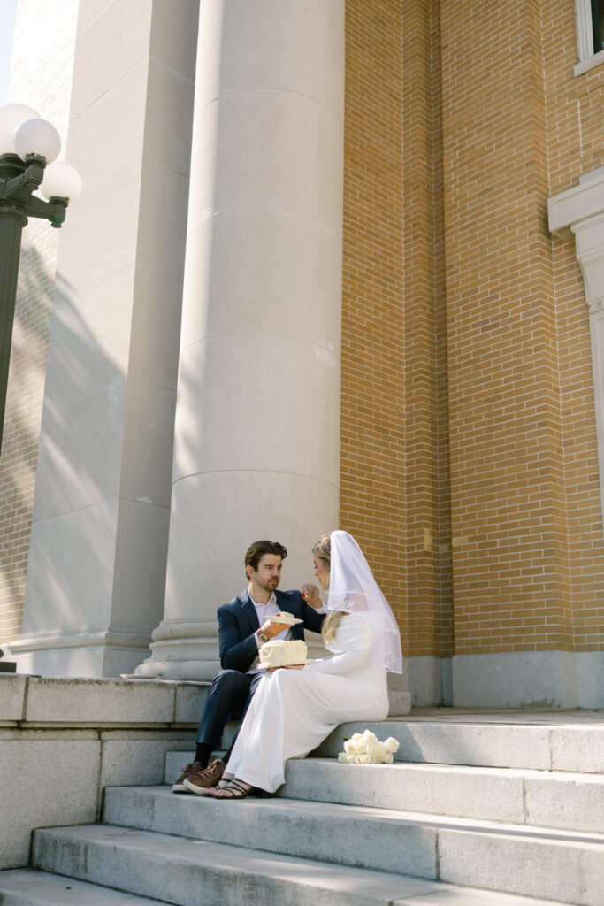 couple sitting on Old Pinellas County Courthouse steps eating cake