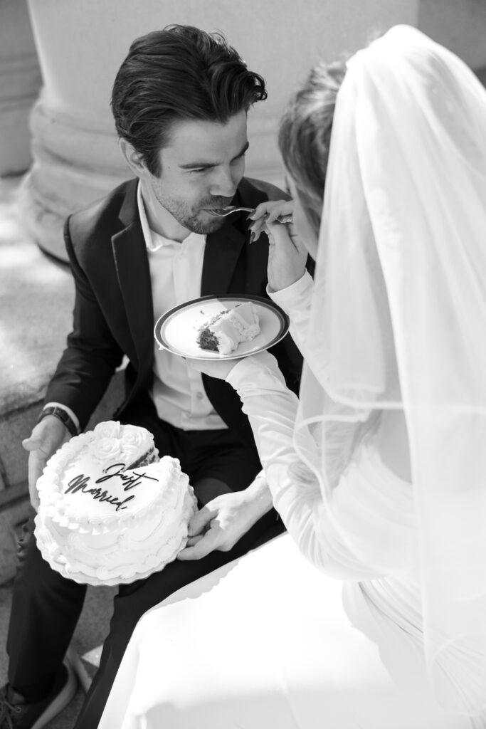 couple sitting on Old Pinellas County Courthouse steps eating cake