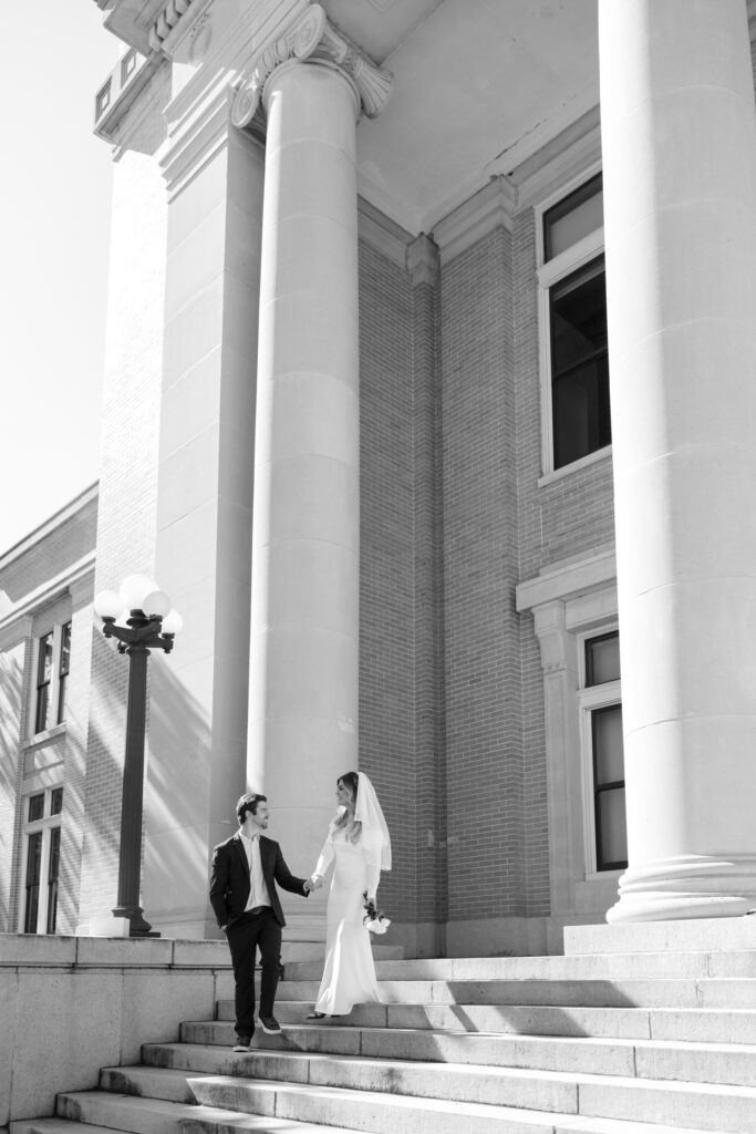 wedding couple walking down Old Pinellas County Courthouse steps