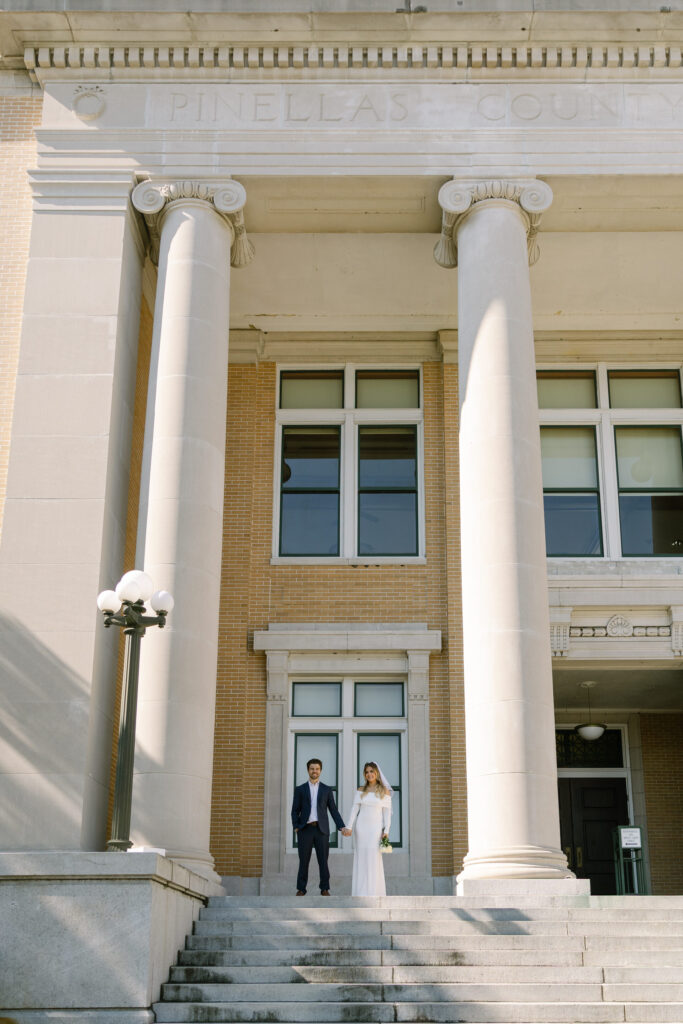 wedding couple standing on platform of Old Pinellas County Courthouse