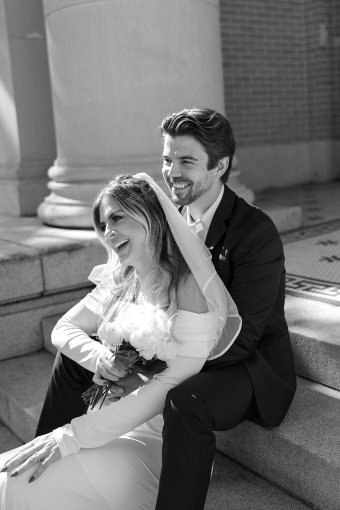 couple sitting on Old Pinellas County Courthouse laughing