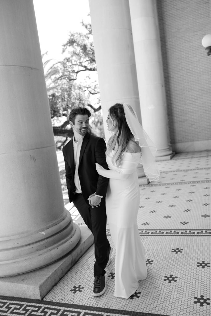 couple walking next to pillars from Old Pinellas County Courthouse