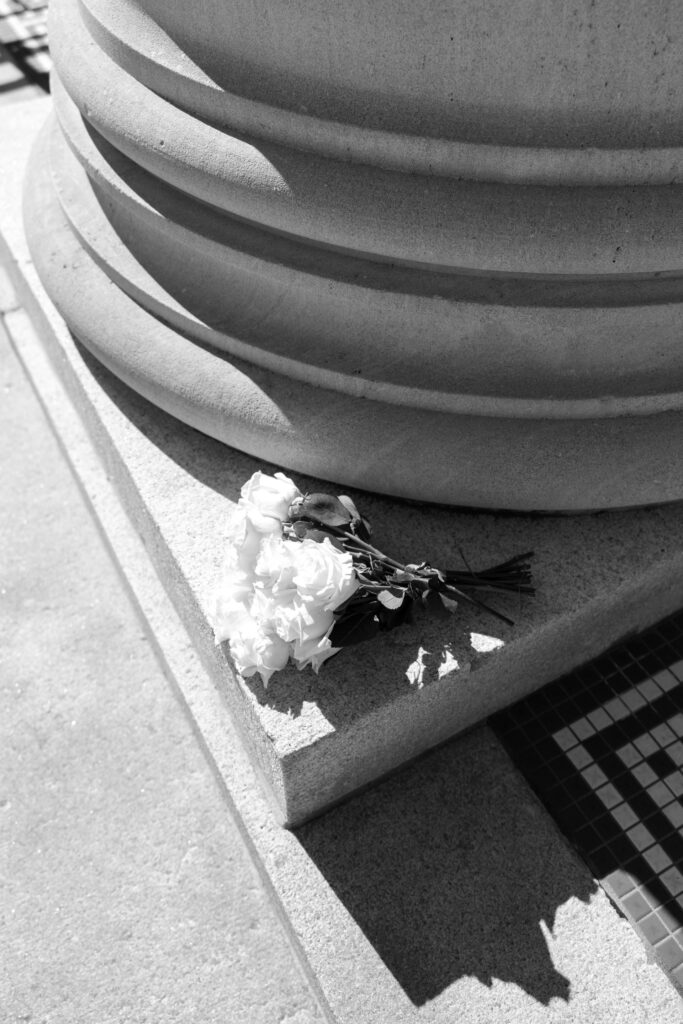 bouquet laying on pillar platform after courthouse wedding